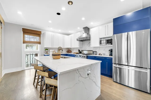 a kitchen with stainless steel appliances granite countertop a stove and a sink