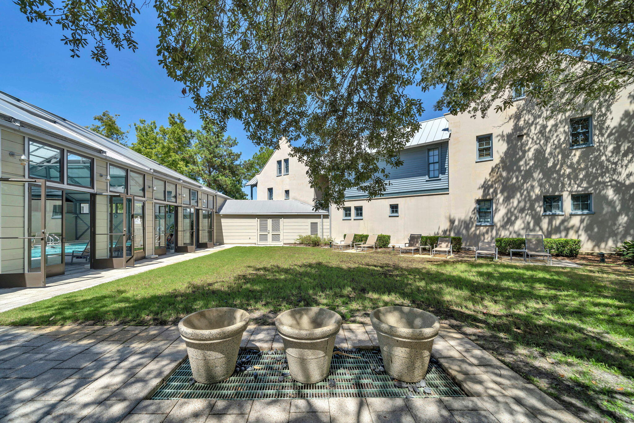 82 South Barrett Square, Unit 3E Inlet Beach, FL 32461 - Photo 43 of 56 a view of a patio with chair and tables back yard of the house