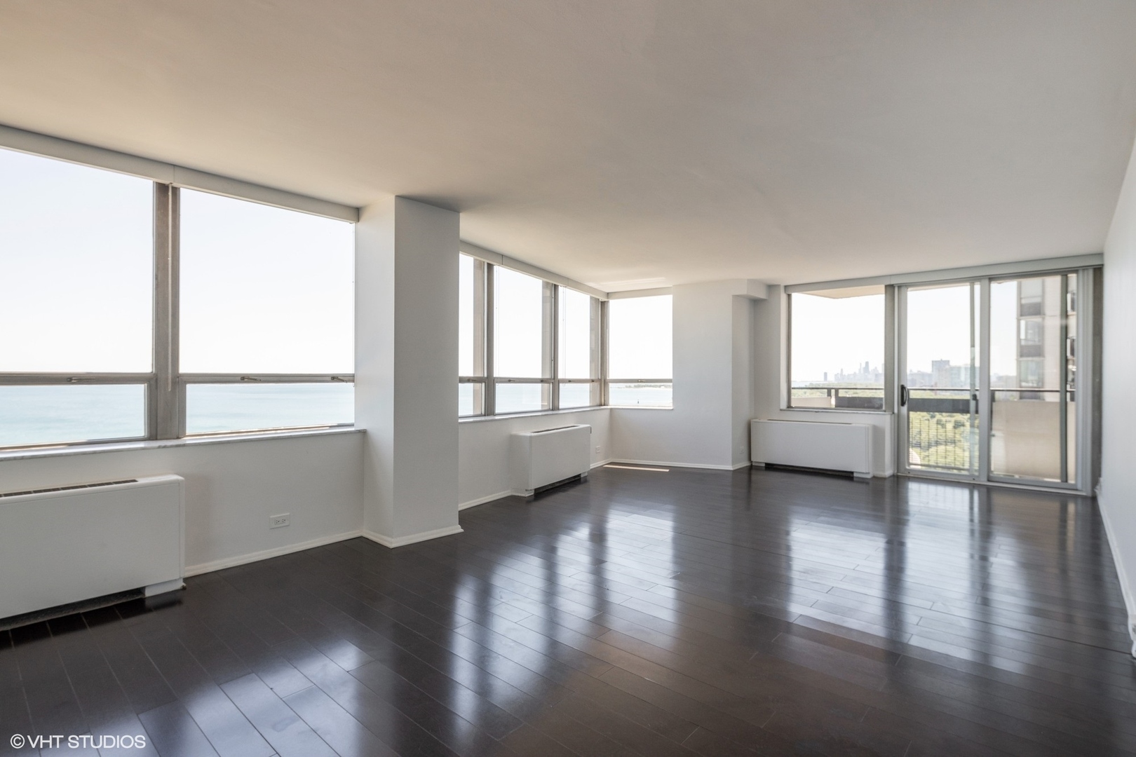 5701 North Sheridan Road, Unit 20J Chicago, IL 60660 - Photo 3 of 25 a view of an empty room with wooden floor and a window