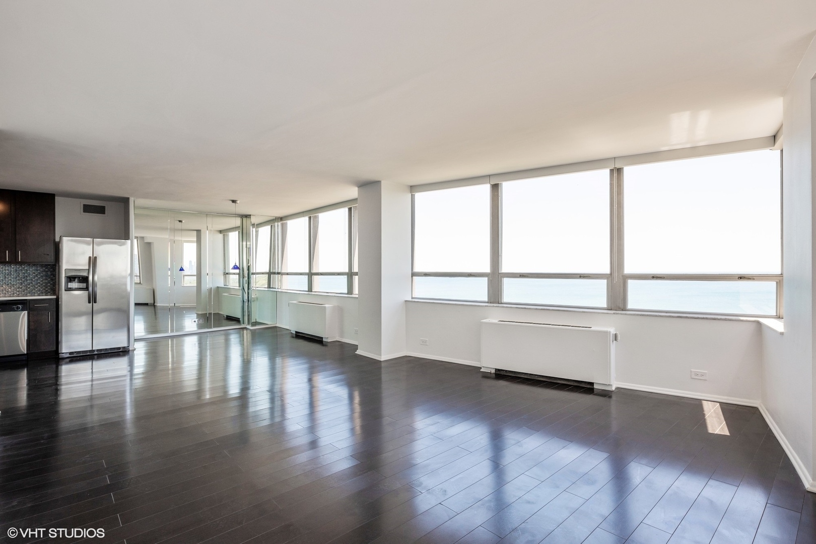 5701 North Sheridan Road, Unit 20J Chicago, IL 60660 - Photo 4 of 25 a view of an empty room with wooden floor and a window