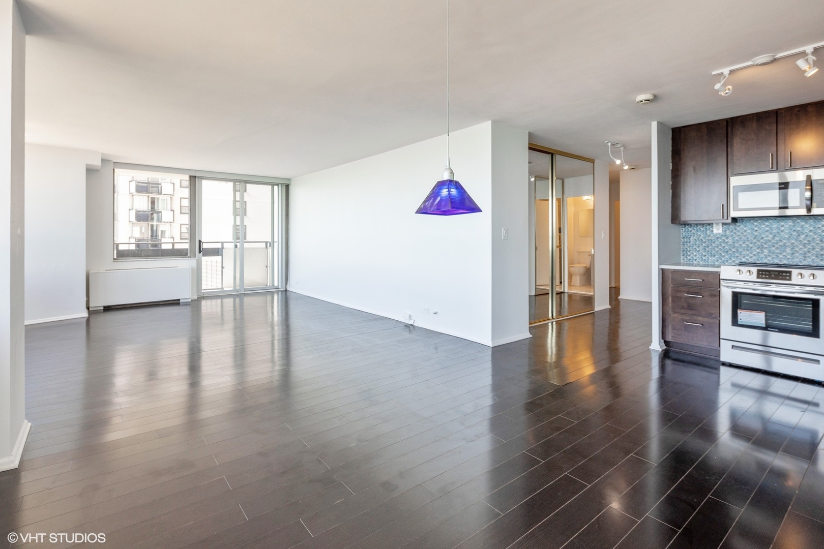5701 North Sheridan Road, Unit 20J Chicago, IL 60660 - Photo 7 of 25 a view of empty room with wooden floor and windows
