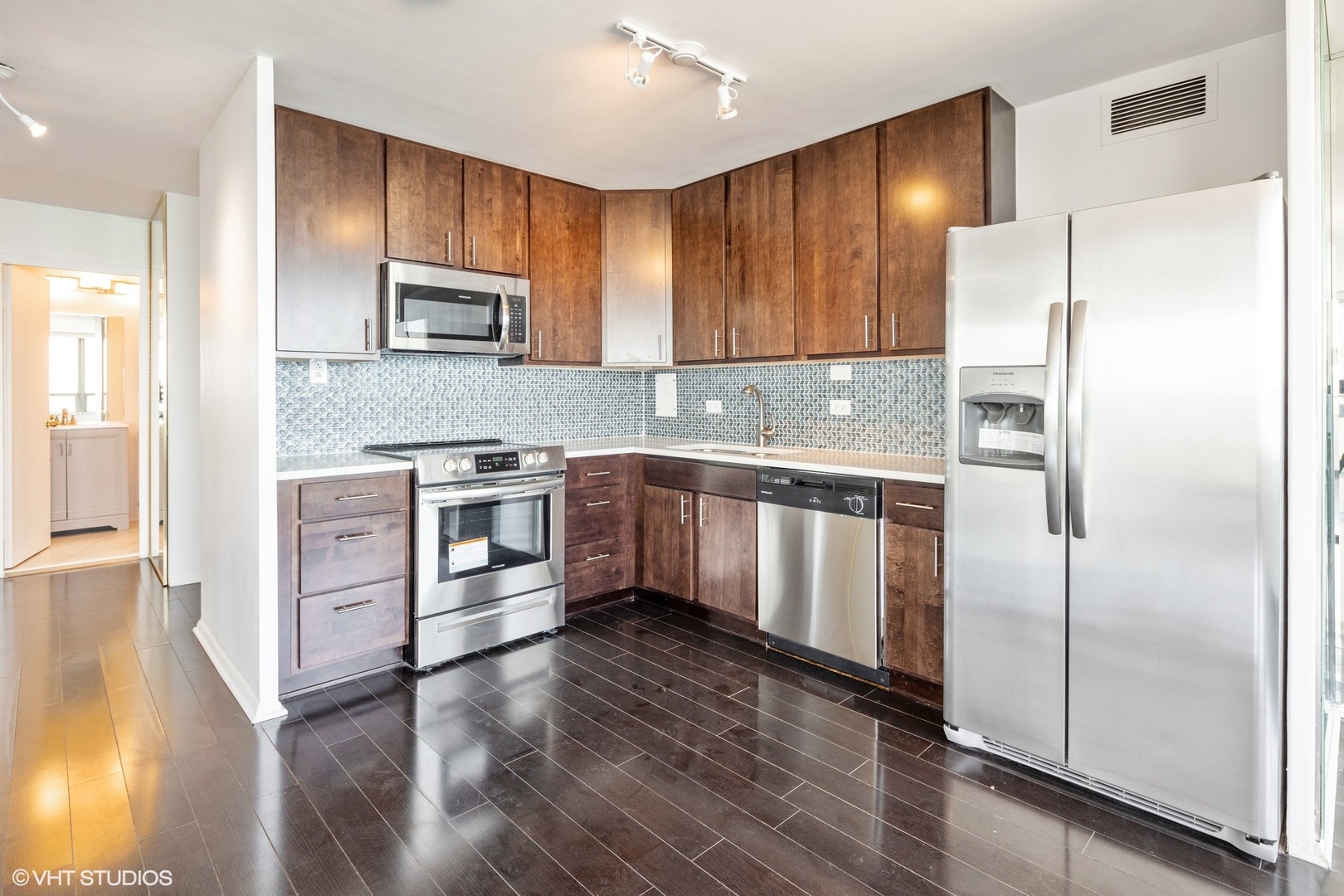 5701 North Sheridan Road, Unit 20J Chicago, IL 60660 - Photo 10 of 25 a kitchen with stainless steel appliances a refrigerator sink and microwave