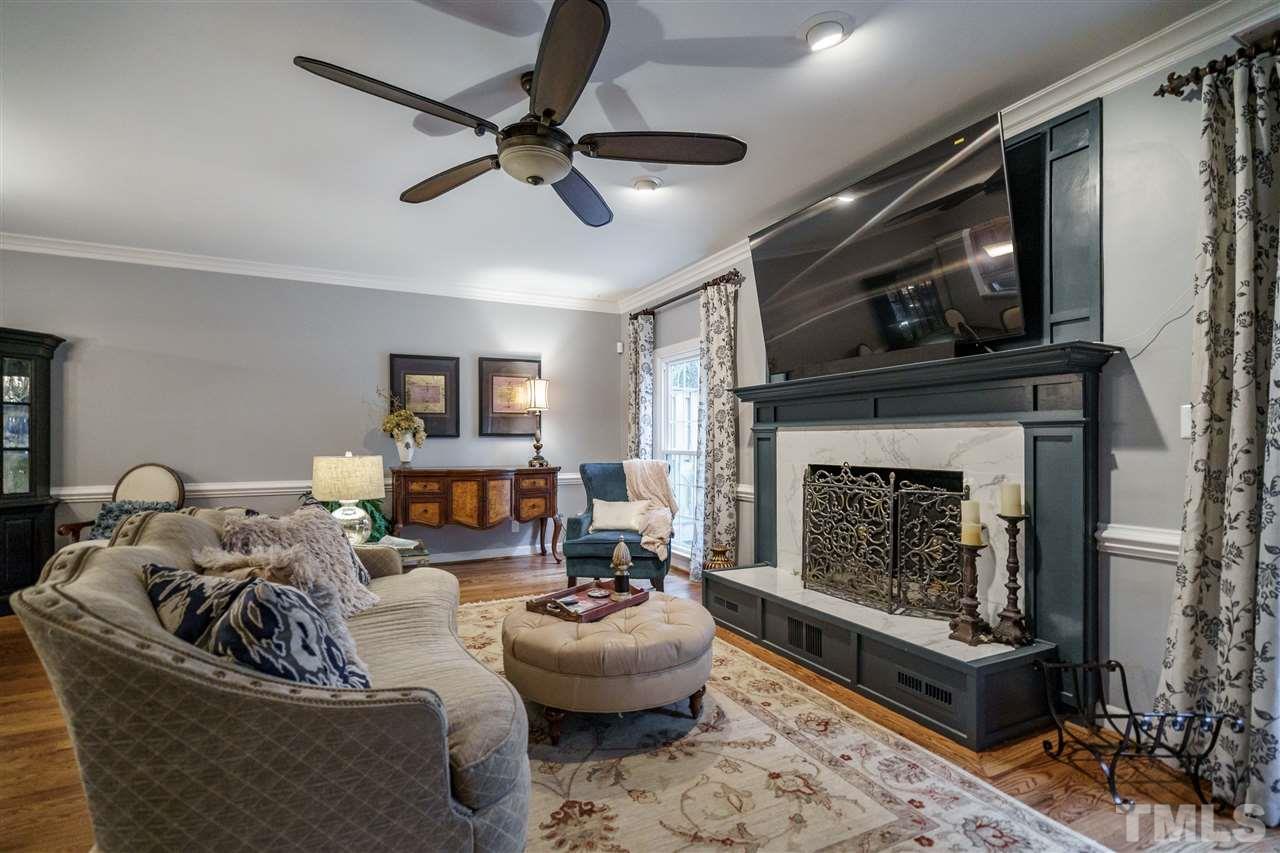 772 Weathergreen Drive Raleigh, NC 27615 - Photo 14 of 26 Wood burning fireplace with marble surround and upgraded millwork.