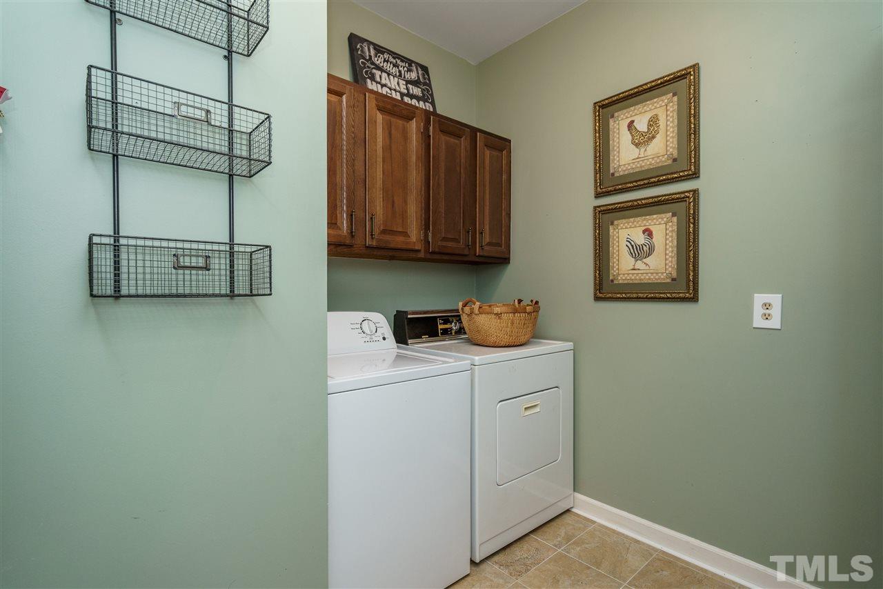 772 Weathergreen Drive Raleigh, NC 27615 - Photo 17 of 26 1st floor utility/laundry with cabinets.