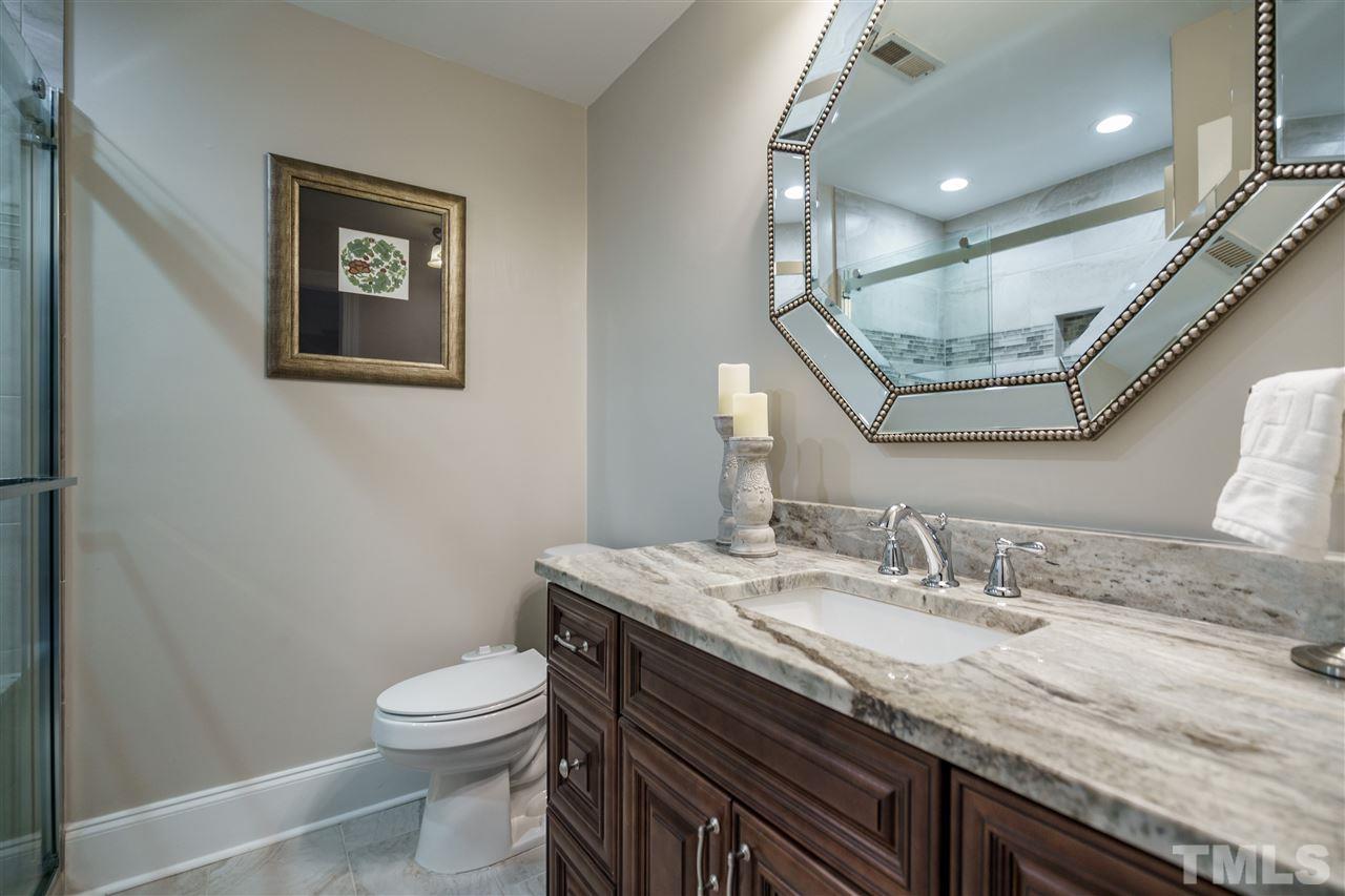 772 Weathergreen Drive Raleigh, NC 27615 - Photo 19 of 26 Features granite vanity and tile flooring.
