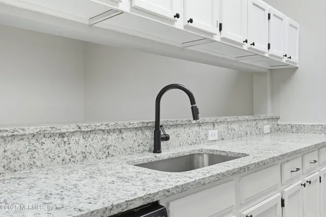 a view of a hallway with wooden floor and chandelier