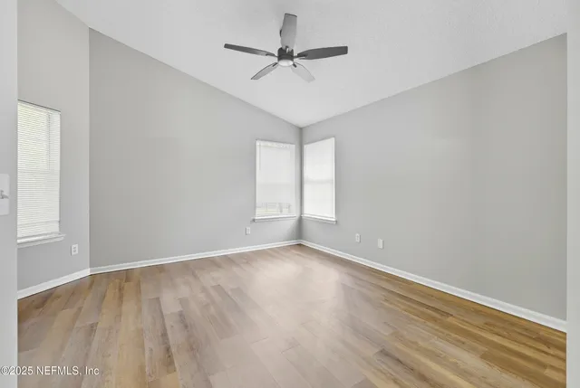 a bathroom with a granite countertop shower sink vanity mirror and toilet
