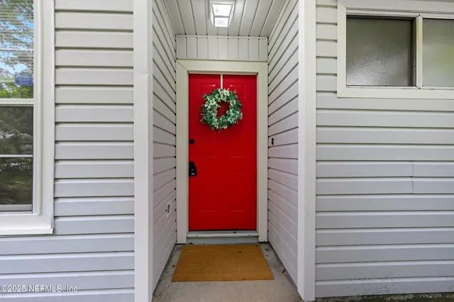 a view of an entryway with wooden floor and window