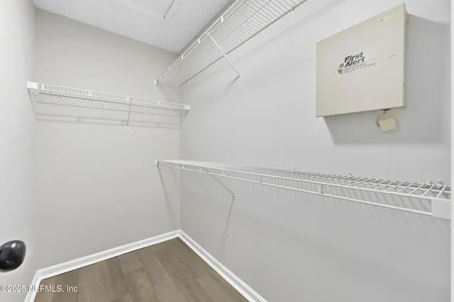 a bathroom with a granite countertop sink a toilet and a mirror