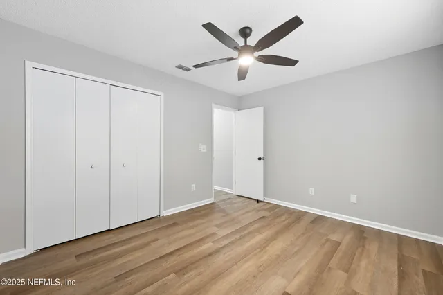 a view of a house with a large window and yard