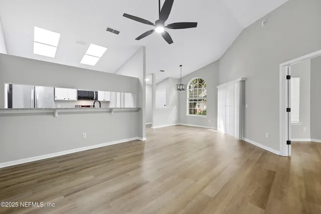 a kitchen with stainless steel appliances granite countertop a sink stove and cabinets