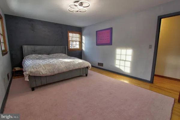 a spacious bedroom with a bed and window