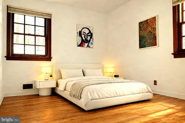 a bedroom with a bed and painting on the wall