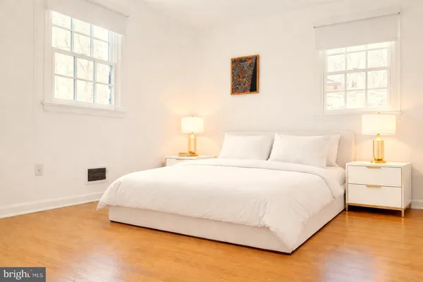 a bedroom with a bed and a window