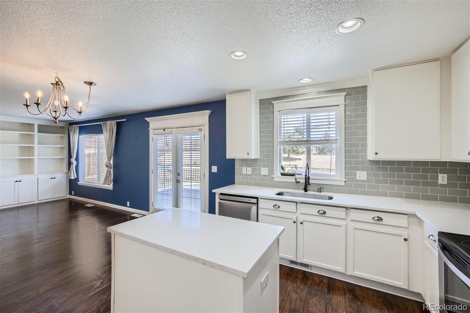 6632 Balance Circle Colorado Springs, CO 80923 - Photo 11 of 28 a kitchen that has a sink a stove and cabinets