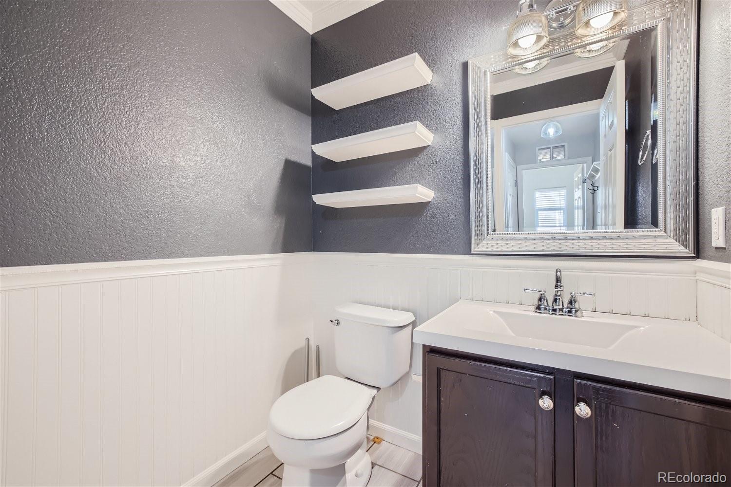 6632 Balance Circle Colorado Springs, CO 80923 - Photo 12 of 28 a bathroom with a sink a toilet and a mirror