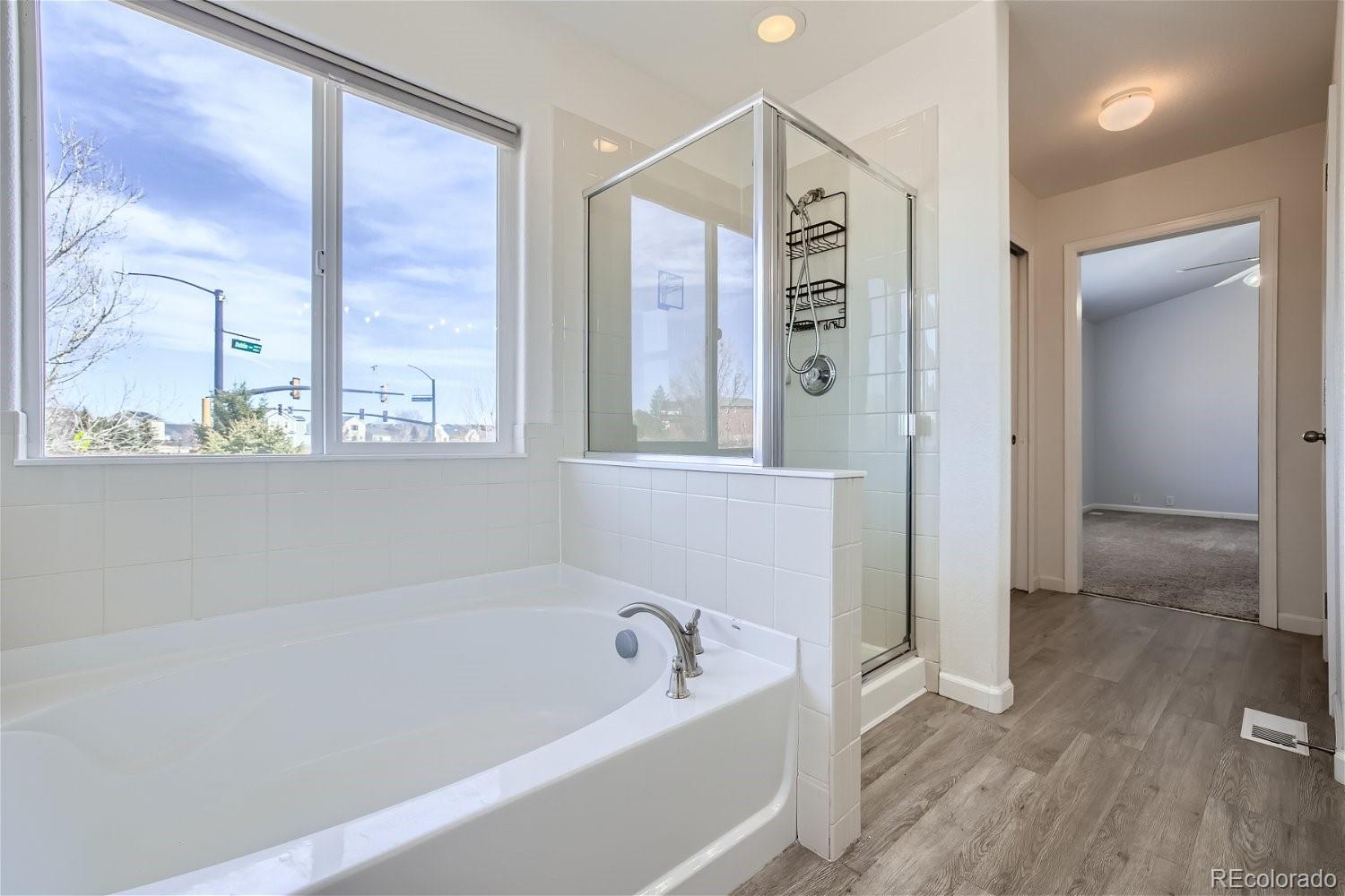 6632 Balance Circle Colorado Springs, CO 80923 - Photo 16 of 28 a bathroom with a bathtub and a shower