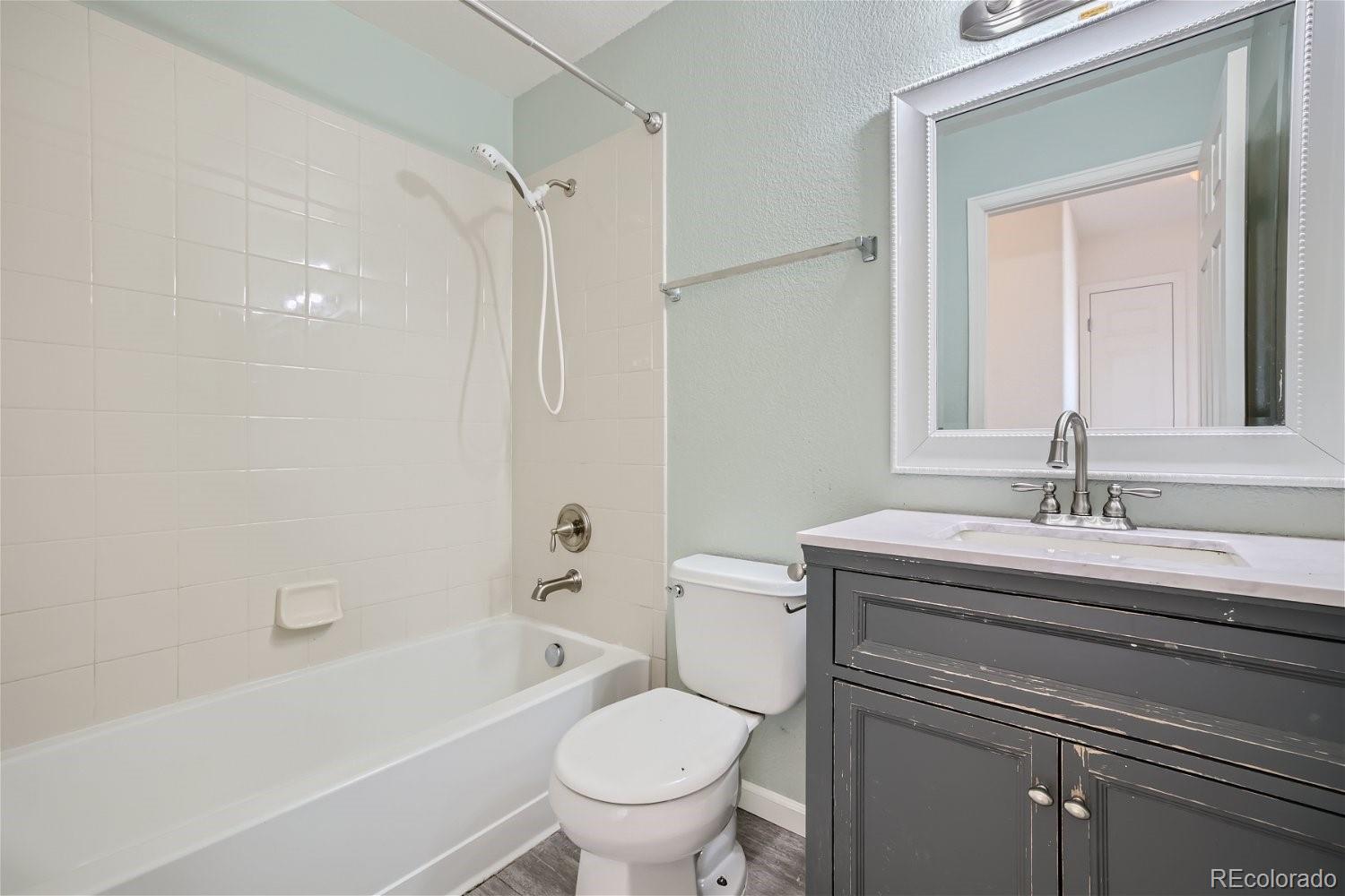 6632 Balance Circle Colorado Springs, CO 80923 - Photo 19 of 28 a bathroom with a granite countertop toilet a sink and a bathtub