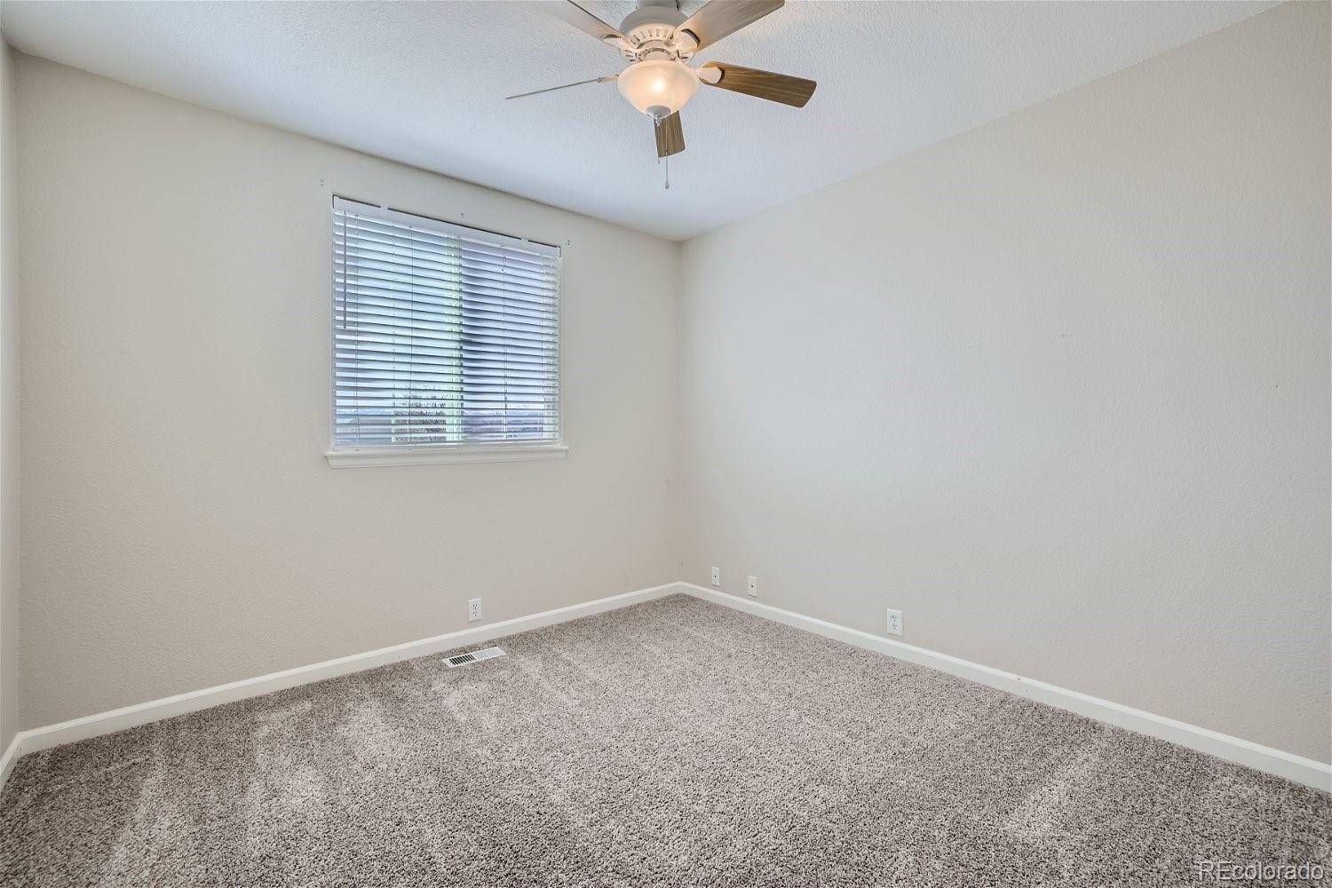 6632 Balance Circle Colorado Springs, CO 80923 - Photo 21 of 28 an empty room with a window and a fan