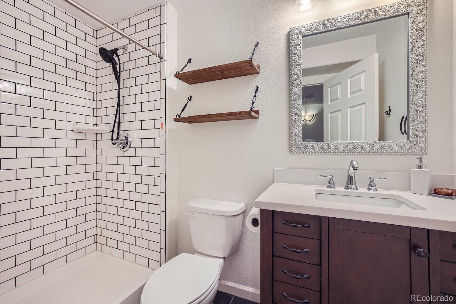 6632 Balance Circle Colorado Springs, CO 80923 - Photo 25 of 28 a bathroom with a sink a toilet and shower