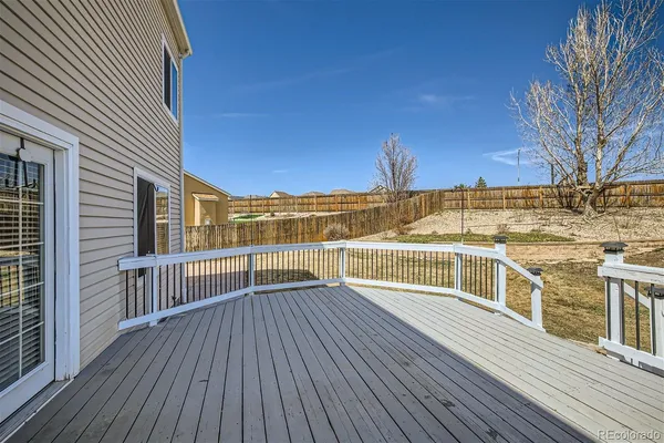 a view of balcony with wooden floor and fence