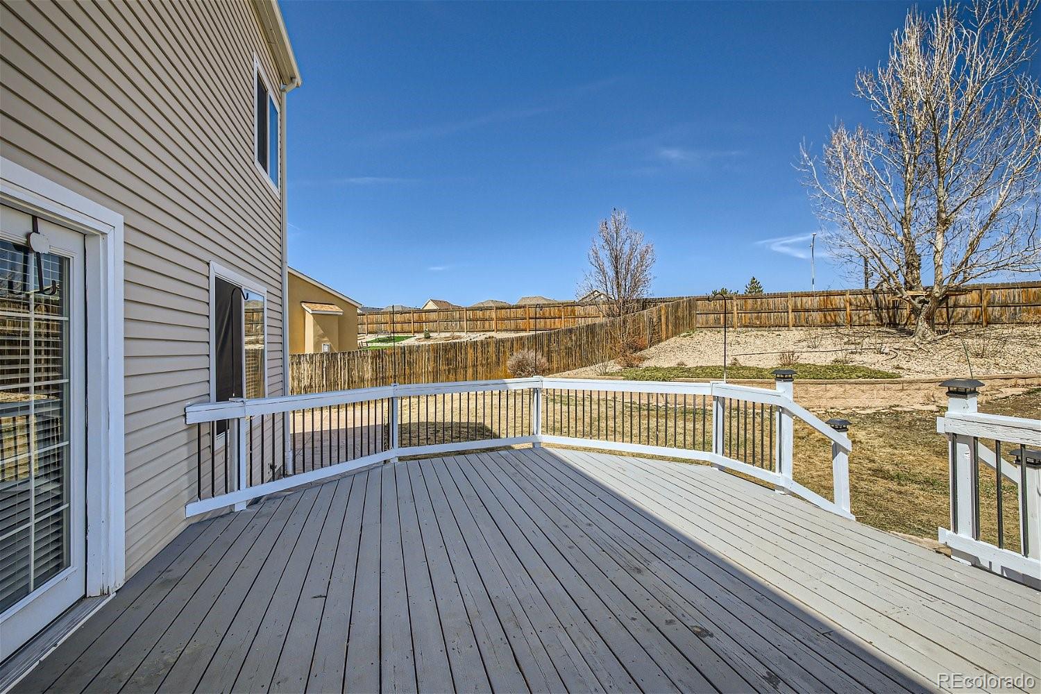 6632 Balance Circle Colorado Springs, CO 80923 - Photo 26 of 28 a view of balcony with wooden floor and fence