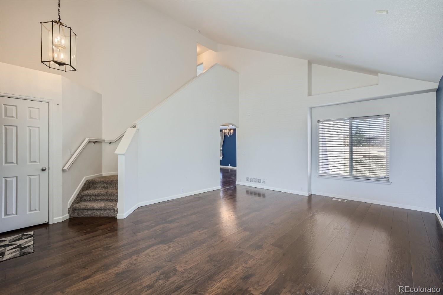 6632 Balance Circle Colorado Springs, CO 80923 - Photo 4 of 28 wooden floor in an empty room with a window