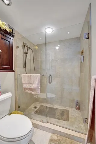 a en suite bathroom with a granite countertop sink and a mirror