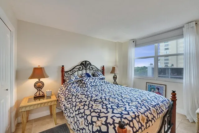 a bedroom with a bed and a mirror on dresser