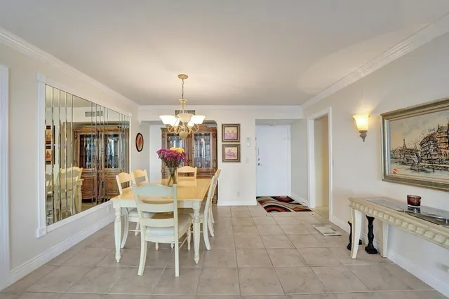 a view of a dining room with furniture and chandelier