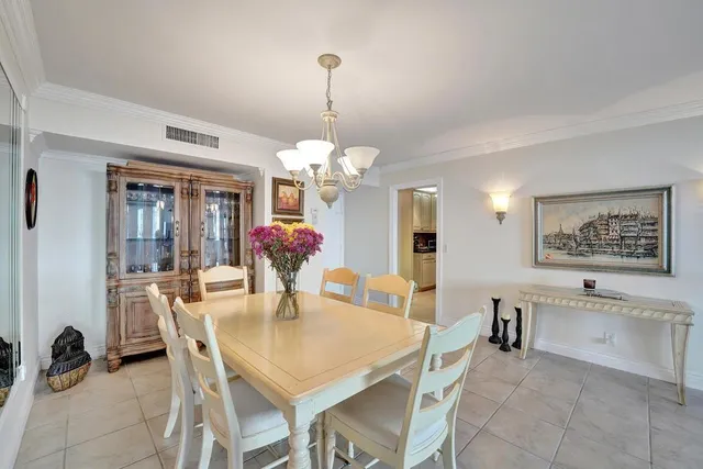 a view of a dining room with furniture and a chandelier