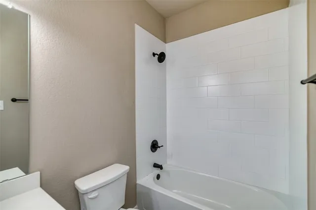 a bathroom with a toilet and a tub