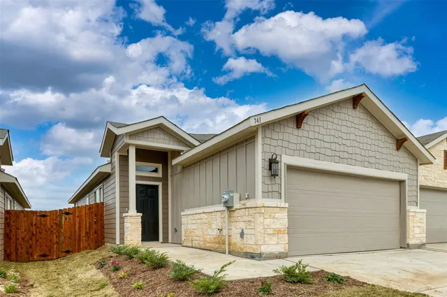 a front view of a house with garage