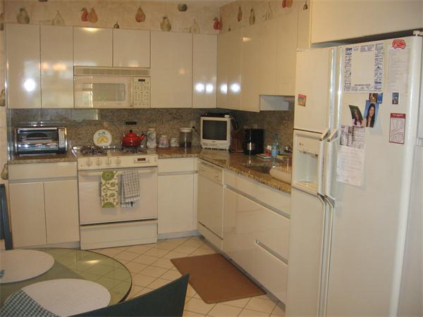 280 Boylston Street, Unit 709 Newton, MA 02467 - Photo 6 of 11 a kitchen with stainless steel appliances a refrigerator sink and cabinets