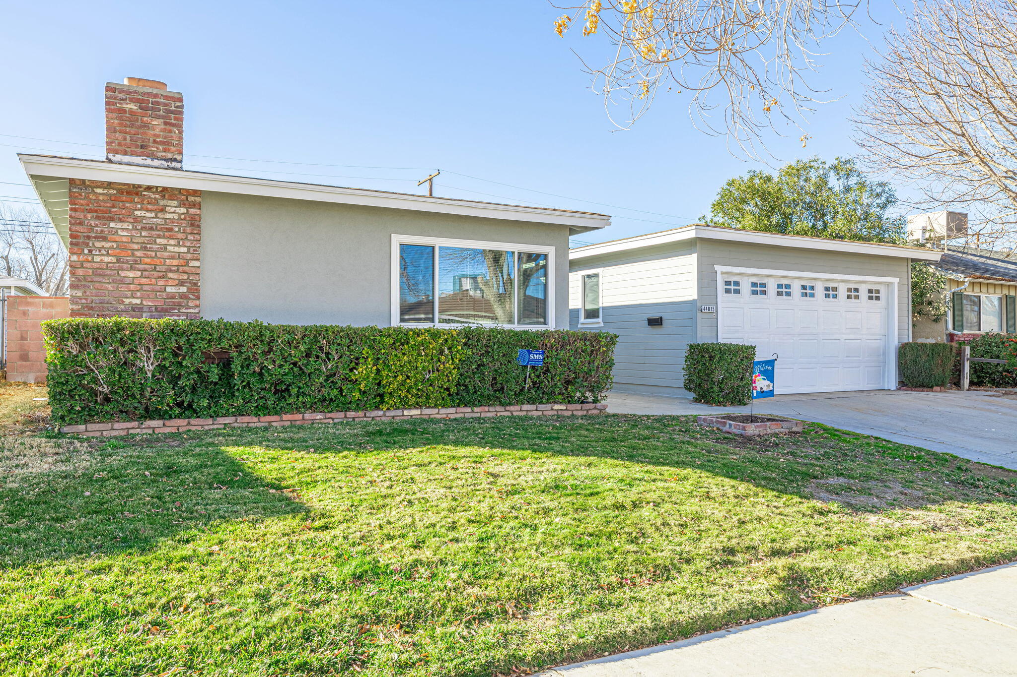 44015 Elm Avenue Lancaster, CA 93534 - Photo 3 of 22 a front view of a house with garden
