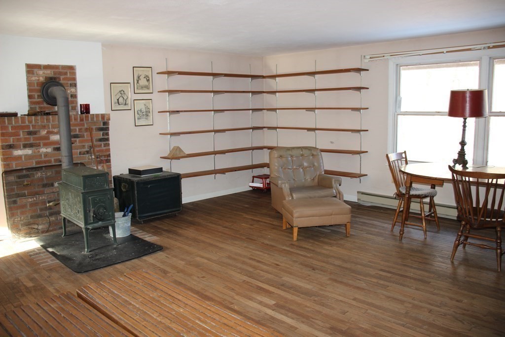 19 Ford Hill Road Rowe, MA 01367 - Photo 24 of 41 a bedroom with a bed a desk and chair with the wooden floor