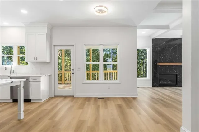 a kitchen with stainless steel appliances granite countertop a sink a stove a refrigerator and island with wooden floor