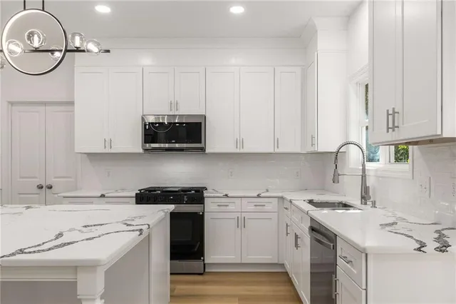 a kitchen with a sink cabinets and a window