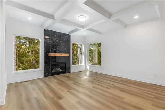 a view of a living room a kitchen and a stove