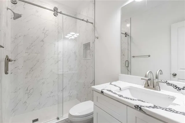 a view of a hallway with wooden floor and stairs
