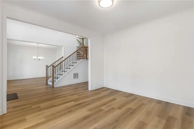 a view of entryway and hall with wooden floor