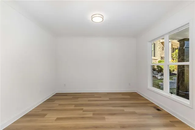 a view of a room with wooden floor and window