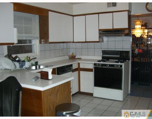 40 Brookside Road Edison, NJ 08817 - Photo 3 of 8 a kitchen with a sink a stove and cabinets