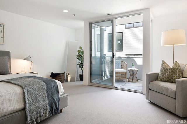 a spacious bedroom with a bed and a couch