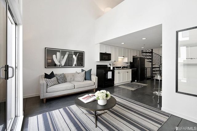 a living room with furniture and kitchen view