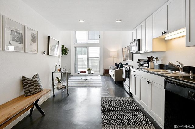a kitchen with sink cabinets and wooden floor