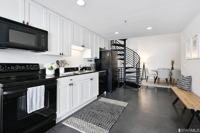 a kitchen with stainless steel appliances a refrigerator a stove a microwave and cabinets