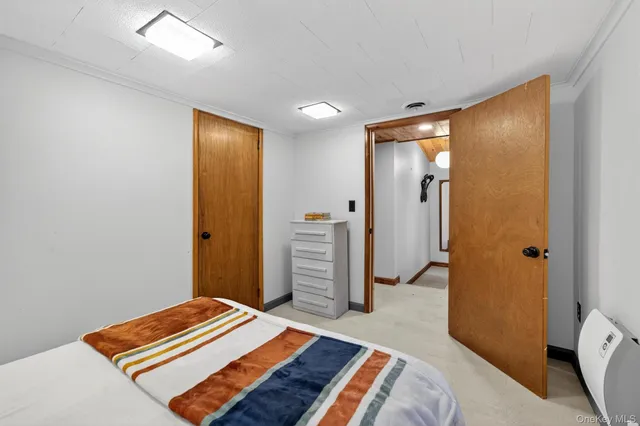 a bedroom with a bed and hallway