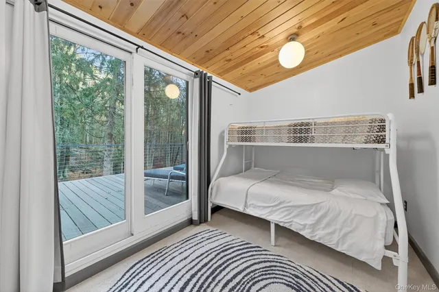 a view of a hallway and wooden floor with a bathroom
