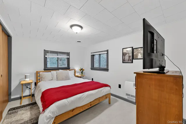 a bedroom with a bed and window